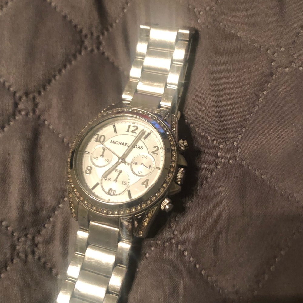 A used Micheal Kors watch with scratches